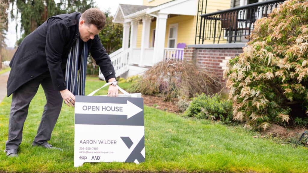Real estate agent placing an open house sign